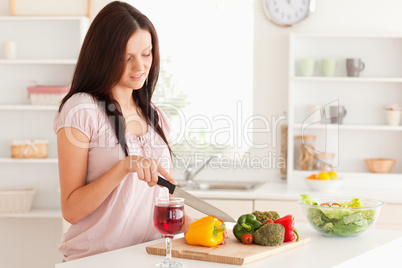 Beautiful woman cutting a pepper