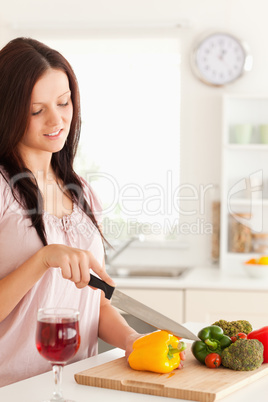 Portrait of a gorgeous woman cutting vegetables