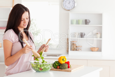 Red-haired woman preparing a salad