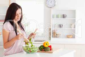 Red-haired woman preparing a salad