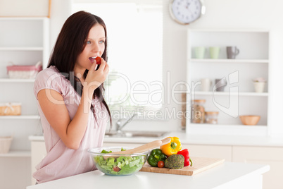 Young woman eating vegetables