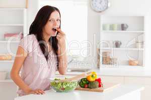 Cute woman eating vegetables