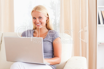 Smiling woman using a laptop Smiling woman using a laptop