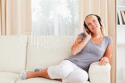 Delighted woman listening to music