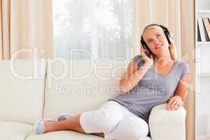 Delighted woman listening to music
