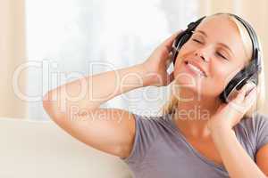 Close up of a pleased woman enjoying some music