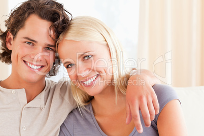 Happy couple sitting on a sofa