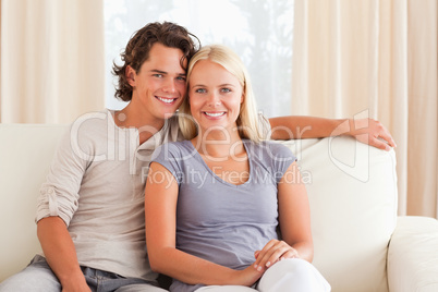 Smiling couple sitting on a sofa