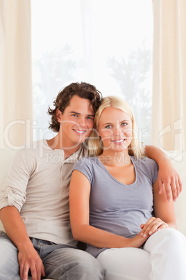 Portrait of a young couple sitting on a sofa
