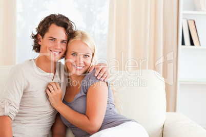 Cheerful couple sitting on a couch