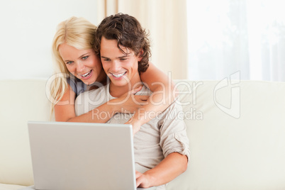 Lovely couple using a notebook