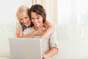 Lovely couple using a notebook