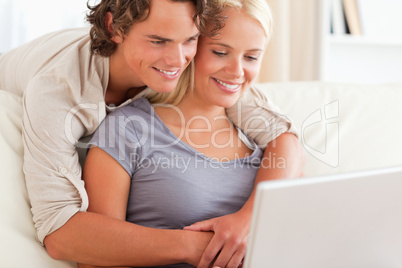 Lovely young couple using a laptop
