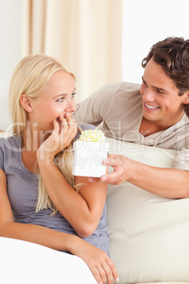 Portrait of a man offering a present to his girlfriend