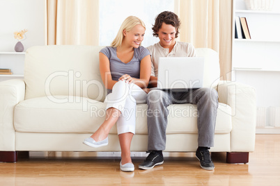 In love young couple using a laptop