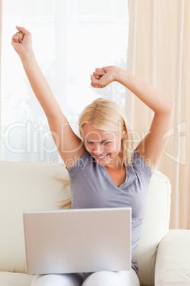 Portrait of an excited woman using a laptop
