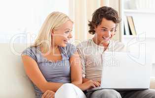 Surprised couple using a laptop