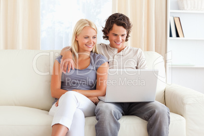Friendly couple using a laptop