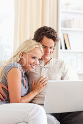 Portrait of a lovely young couple using a laptop