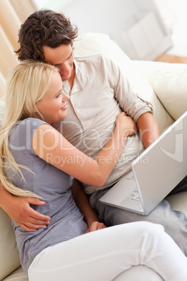 Happy young couple using a laptop