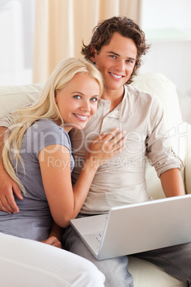 Portrait of a happy young couple with a notebook