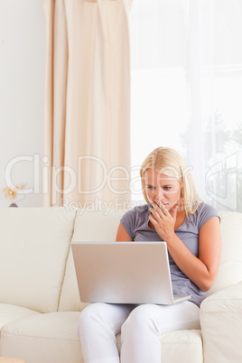 Portrait of a worried woman using a laptop