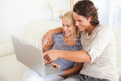 Man showing something to his wife on a notebook