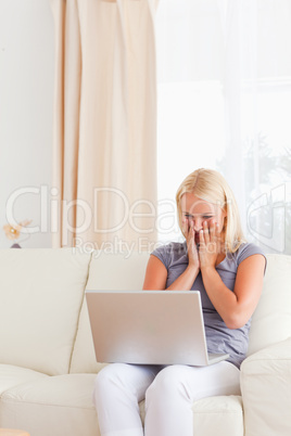 Sad woman using a laptop