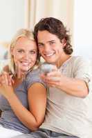 Portrait of a cute couple watching TV