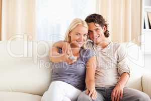 Smiling couple watching TV