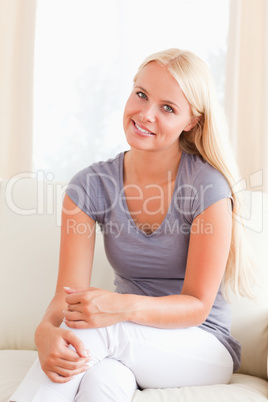 Lovely woman sitting on a sofa