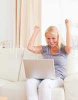 Woman sitting on a sofa while using a laptop