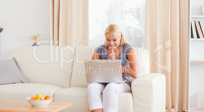 Excited woman using her laptop