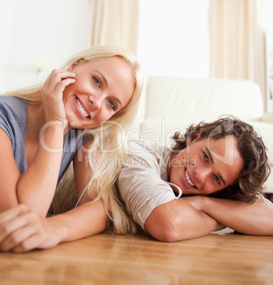 Close up of a cute couple lying on the floor