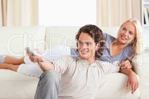 Cute young couple watching TV