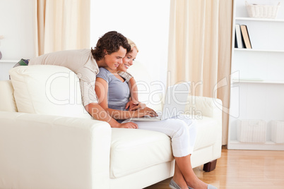 Smiling young couple using a notebook