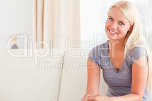 Blonde woman sitting on her sofa