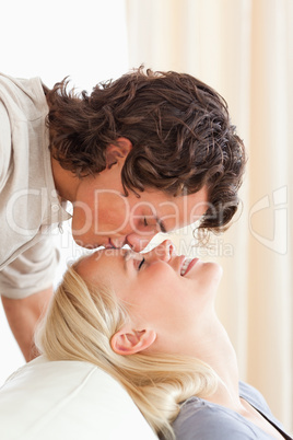 Portrait of a man kissing his fiance on the forehead