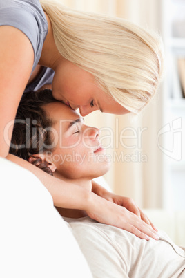 Portrait of a woman kissing her fiance on the forehead