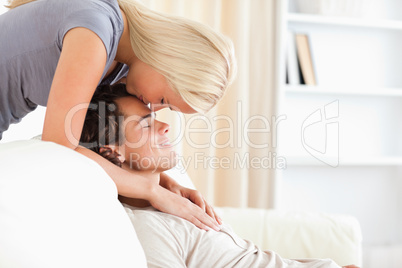 Woman kissing her fiance on the forehead