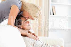 Woman kissing her fiance on the forehead