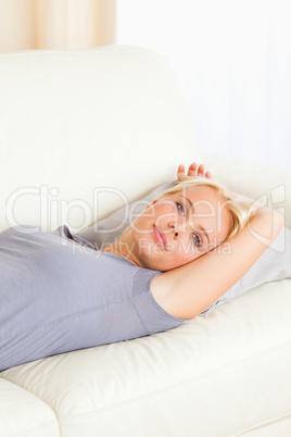 Portrait of a cute woman lying on a sofa