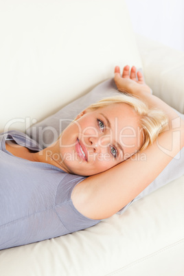 Portrait of gorgeous woman lying on a sofa