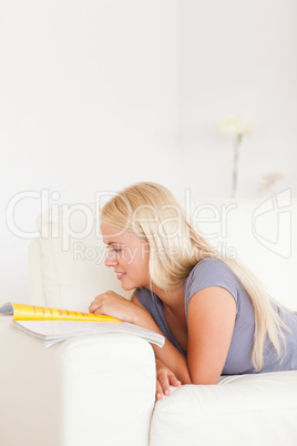 Portrait of a delighted woman reading a magazine