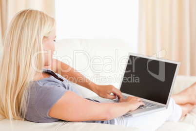 Blonde woman using a laptop