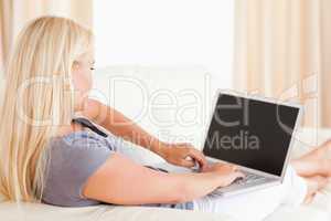 Blonde woman using a laptop