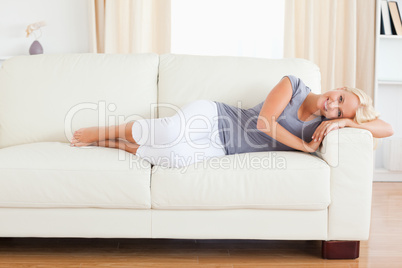 Beautiful woman resting on a sofa