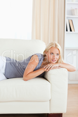 Portrait of a woman lying on a sofa