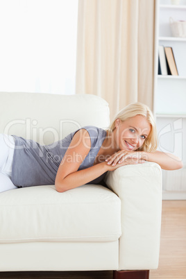 Portrait of a smiling woman lying on a sofa