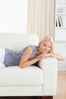 Portrait of a beautiful woman lying on a sofa